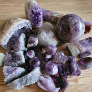 Photo of a variety of amethysts, polished, figures and raw.  hues from strong purple to light lavender.