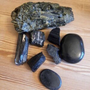 Black Tourmaline variatons. Raw pieces, including af big raw green tourmaline and worry stones.